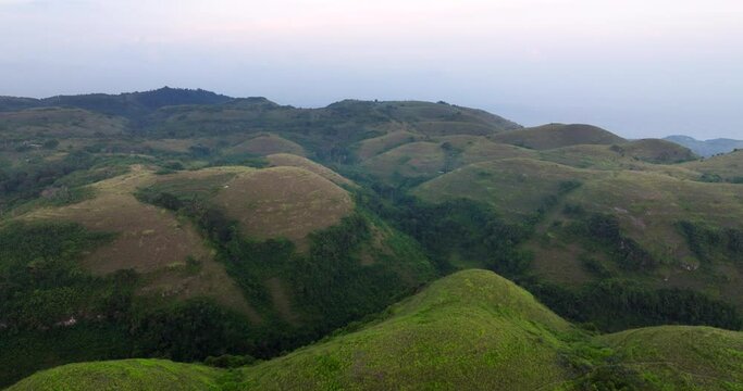 Aerial View Of Lush Green Hills Of Bukit Teletubbies Hill In Nusa Penida, Bali, Indonesia During Sunset. 