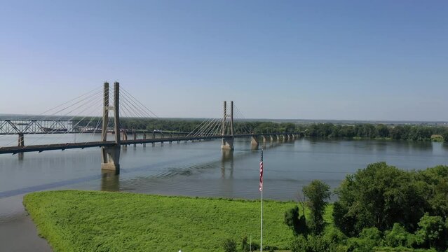 Aerial of the Bayview Bridge in Quincy, Illinois on a calm river with green trees in the background