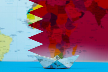 Sea transport of Bahrain concept, paper ship with Bahrain flag, cargo and logistics idea