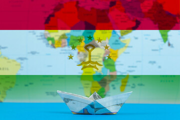 Sea transport of Tajikistan concept, paper ship with Tajikistan flag, international transportation 