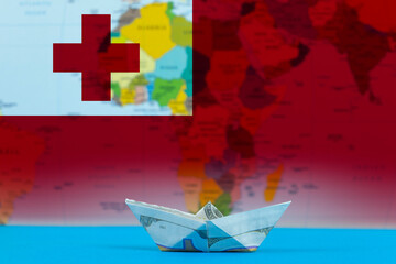 Sea transport of Tonga concept, paper ship with Tonga flag, cargo and logistics idea, bulk carrier 