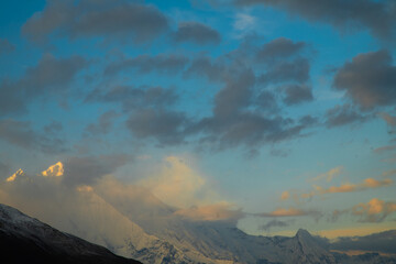 Soft clouds drifting across a blue evening sky © sbjshah