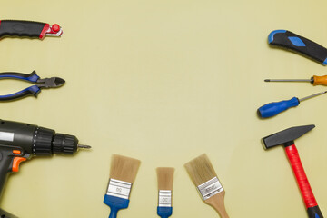 Set of tools for builder and electrician on a yellow background. Flat layout. There is space for...