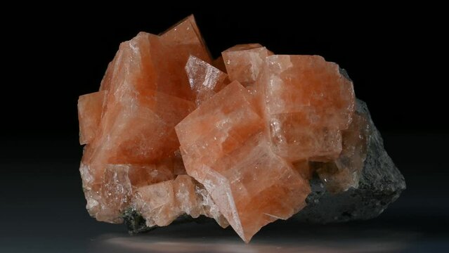 Chabazite crystals (tectosilicate mineral of the zeolite group) sample rotating slowly .	