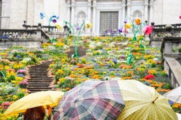 Spanish flower festival with rain and umbrellas. Temps de flors