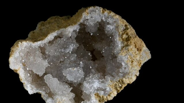Geode containing quartz crystals, rotating slowly against a black background (Mendip, Somerset, UK)