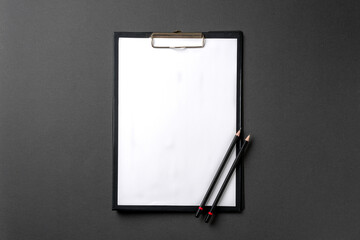 Blank A4 paper attached to the clipboard and pencil on it