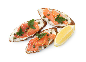 Tasty canapes with salmon, capers, lemon and cream cheese isolated on white, top view