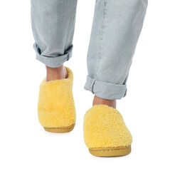 Woman in yellow soft slippers on white background, closeup