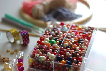Various craft supplies on white background. Supplies for jewelry making, drawing and needlework. Selective focus.