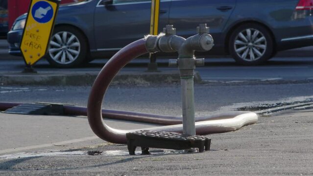 A well in a street has been opened and a fire hydrant connection point to supply water on road in england uk.