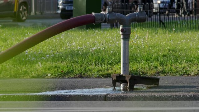 A well in a street has been opened and a fire hydrant connection point to supply water on road in england uk.
