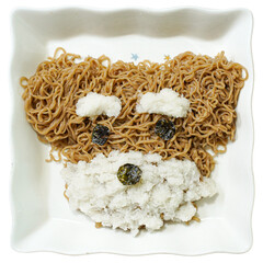 Buckwheat noodles plated in the shape of a dog's face