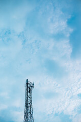 tower, gadget operator signal transmitter tower with clouds and clear, blue sky