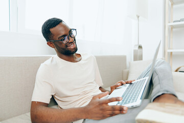 Smiling African American Freelancer Working on Laptop in Modern Home Office