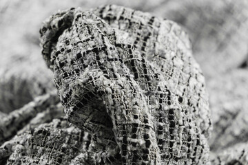 Close-up of texture of draped white and black tweed woven fabric textile background, Chanel style classic fabric.
