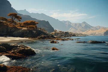 Nature of Oman. Rocky shoreline with a small town in the distance.  Mountains in the background....