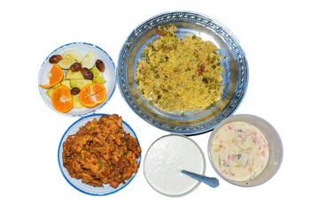 Tasty Indian food meal of fried rice with mixed vegetables along with red hot spicy lobster dish garnished with salad and spicy chili chicken