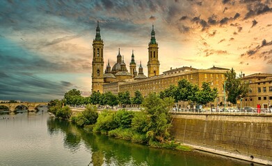 Iconic View of Zaragoza's Cathedral and Waterfront at Sunset