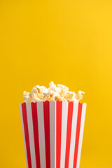 Popcorn on a yellow background. 
fast food