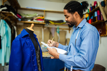 African American men fashion designer, tailor drawing a sketch for his new design