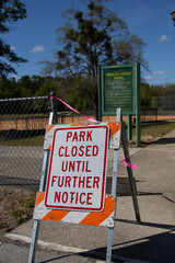 Sign at a park announcing closure due to Covid-19 virus