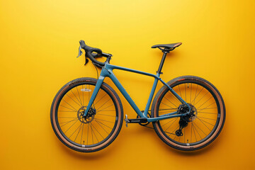 Fototapeta premium Gravel bike on yellow background with copy space. Road sport bike, close up. Minimalist backdrop with bicycle