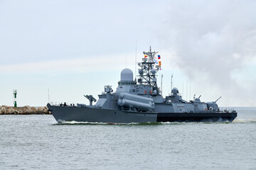 Russian warship armed with armament sails into sea toward military target to attack and destroy enemy, military ship performing strategic maneuver, Russian sea power deployment for tactical advantage