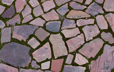 Ancient walking path paved with red granite with straight edges
