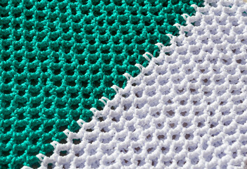 Texture of knitting polyester cord in green and white colors. Women's bags made of polyester cord.