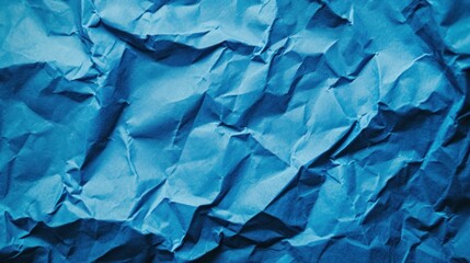 Blue crumpled paper texture in low light background