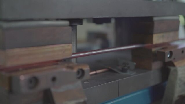 Factory production of heating element. Heating exchanger workshop. Inserting heat wire into copper tubes or pipes. Mass factory production.