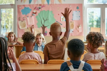 boy raising hand while answering in class at elementary school