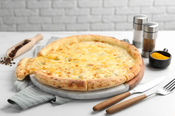 Delicious cheese pizza served on white table