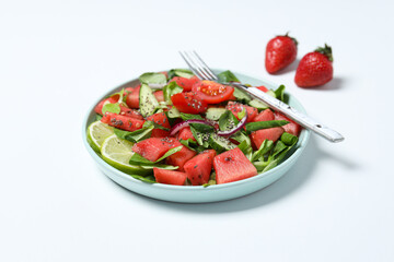 Watermelon salad in a bowl with strawberries and lime