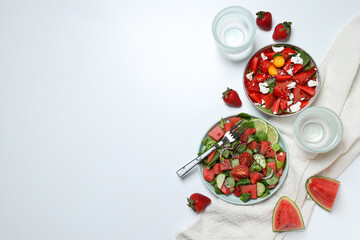 Watermelon salad in bowls with strawberries on a white background