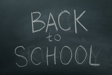Chalk writing on the blackboard: "Back to school"