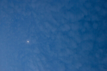 beautiful sky landscape Blue thin clouds and a moon There is space for text. Crescent moon.