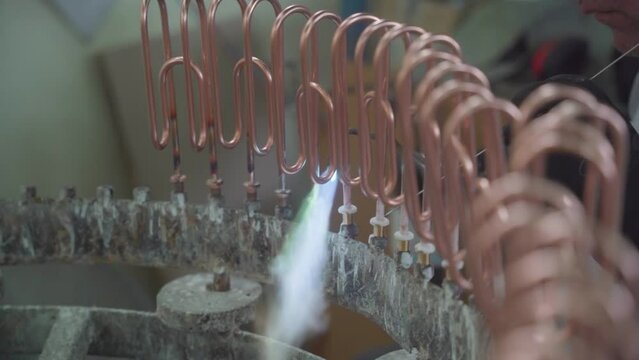 Factory production of heating element. Welding of Heating exchanger in workshop. Manufacturing heating element. Mass factory production.