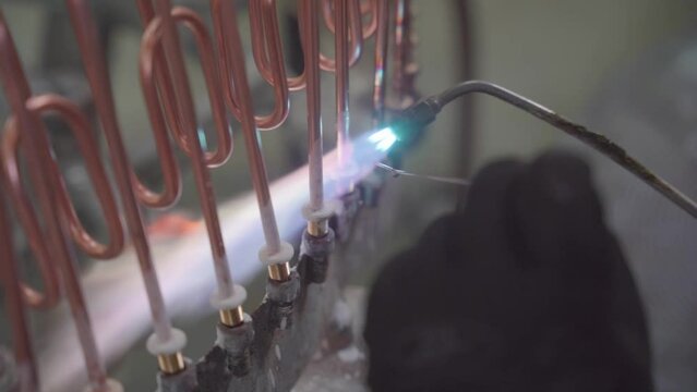 Factory production of heating element. Welding of Heating exchanger in workshop. Manufacturing heating element. Mass factory production.