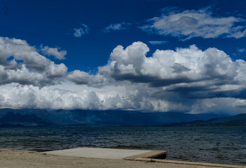 Azure Serenity. Cloud-Dappled Skies Above Tranquil Concrete Floor.