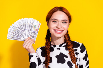 Photo of funky positive woman wear cow skin print top rising dollars fan smiling isolated yellow...