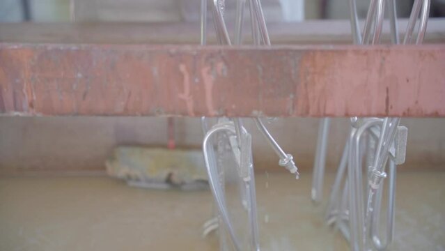 Factory production of heating element. Heating exchanger workshop. Washing and Polishing finished heating element, lowering the heater into the tub.