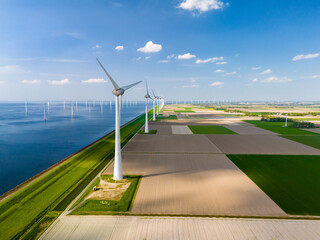 A breathtaking aerial view captures a wind farm in the Netherlands Flevoland region, with rows of...