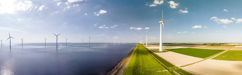 A vast expanse of water surrounded by towering windmills in Flevoland, Netherlands, harnessing the power of the wind to generate renewable energy