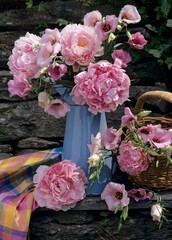 still life of pink peonies in a blue metal jug outdoors