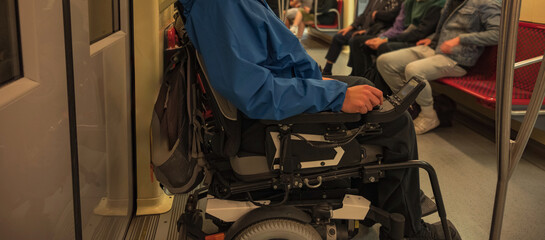 Man with disability with electric wheelchair on train. Inclusive and accessible public...