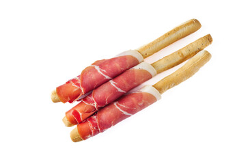 crispy grisini with prosciutto on a white background