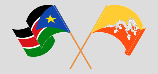 Crossed and waving flags of South Sudan and Bhutan