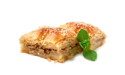 Eastern sweets. Pieces of tasty baklava with mint isolated on white